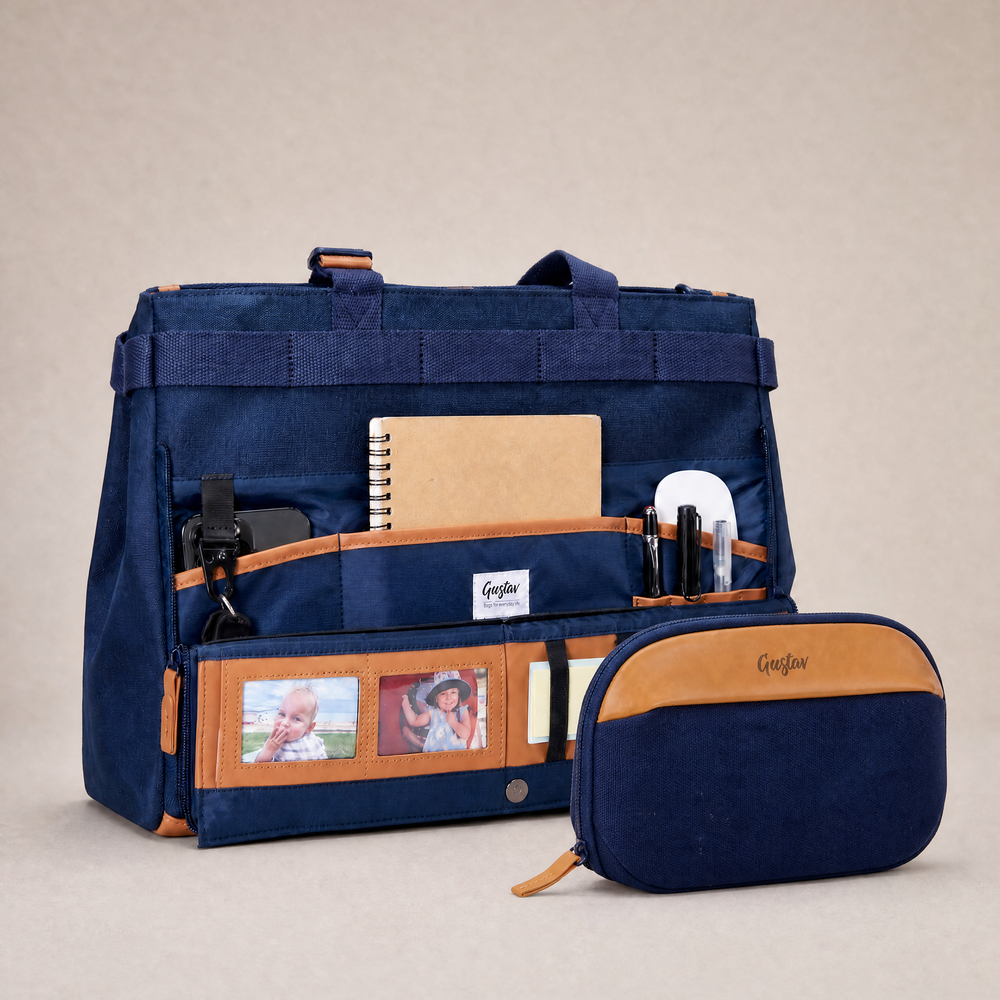 Navy blue bag with brown accents and a smaller matching pouch on a beige background
