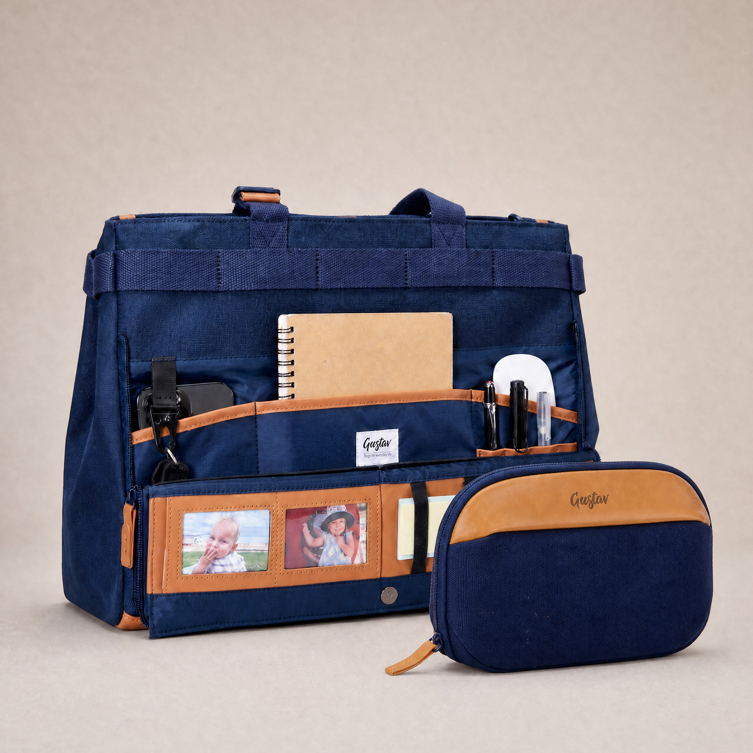 Navy blue bag with brown accents and a smaller matching pouch on a beige background