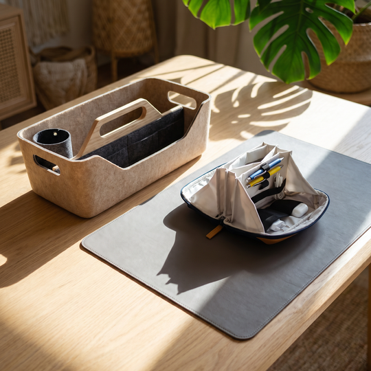 Desk setup with a container, notebook, and stationery on a wooden desk.